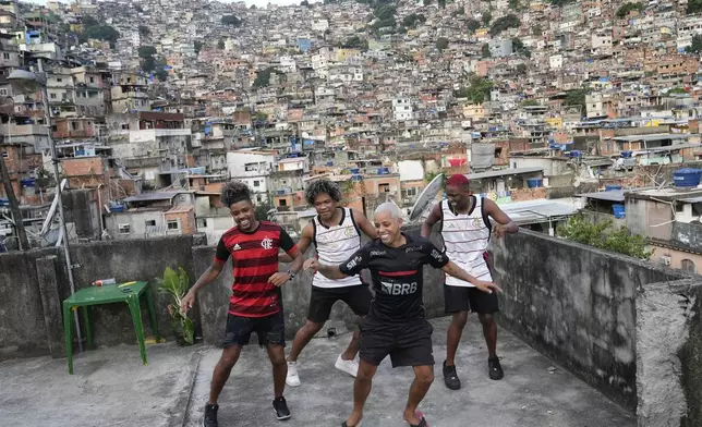 Youth perform a street dance style known as passinho for their social media accounts, in the Rocinha favela of Rio de Janeiro, Brazil, Wednesday, April 17, 2024. The passinho, or “little step”, created in the 2000s by kids in Rio’s favelas, was declared an “intangible cultural heritage” by state legislators, bringing recognition to a cultural expression born in the sprawling working-class neighborhoods. (AP Photo/Silvia Izquierdo)