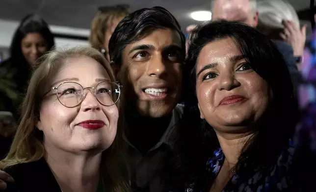 Britain's Prime Minister Rishi Sunak poses with supporters for pictures after a Tory party rally at the Amersham and Chiltern Rugby club in Amersham, England, Monday, May 27, 2024.(AP Photo/Alastair Grant, Pool)