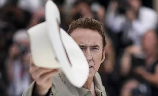 Nicolas Cage poses for photographers at the photo call for the film 'The Surfer' at the 77th international film festival, Cannes, southern France, Friday, May 17, 2024. (Photo by Daniel Cole/Invision/AP)