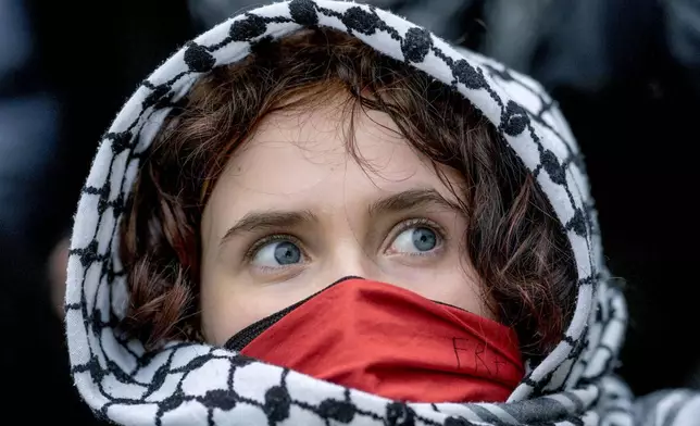 A young woman looks on during a pro-Palestinians demonstration by the group "Student Coalition Berlin" in the theater courtyard of the 'Freie Universität Berlin' university in Berlin, Germany, Tuesday, May 7, 2024. Pro-Palestinian activists occupied a courtyard of the Free University in Berlin on Tuesday. (AP Photo/Markus Schreiber)