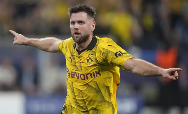 Dortmund's Niclas Fuellkrug celebrates after scoring his side's opening goal during the Champions League semifinal first leg soccer match between Borussia Dortmund and Paris Saint-Germain at the Signal-Iduna Park stadium in Dortmund, Germany, Wednesday, May 1, 2024. (AP Photo/Matthias Schrader)