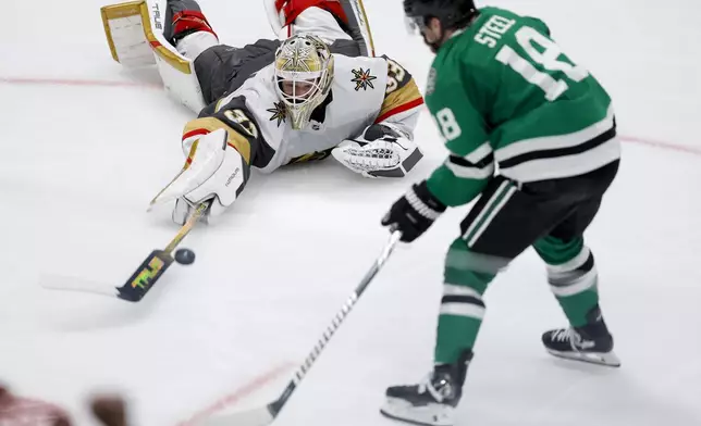 Vegas Golden Knights goaltender Adin Hill, top, leaves his crease to make a save on a breakaway by Dallas Stars center Sam Steel (18) during the third period in Game 7 of an NHL hockey Stanley Cup first-round playoff series, Sunday, May 5, 2024, in Dallas. (AP Photo/Brandon Wade)
