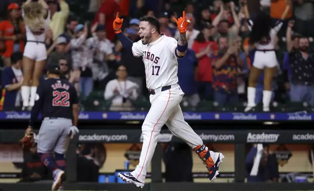 Houston Astros' Victor Caratini (17) rounds the bases as he celebrates his walk-off home run against the Cleveland Guardians during the 10th inning of a baseball game Tuesday, April 30, 2024, in Houston. (AP Photo/Michael Wyke)