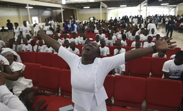 A woman wails during the funeral service for Saintus Leodens who was killed by unknown assailants, in Port-au-Prince, Haiti, Saturday, May 25, 2024. (AP Photo/Odelyn Joseph)