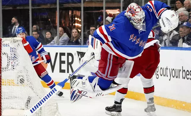 Carolina Hurricanes right wing Andrei Svechnikov (37) trips New York Rangers goaltender Igor Shesterkin (31) during the first period in Game 2 of an NHL hockey Stanley Cup second-round playoff series, Tuesday, May 7, 2024, in New York. (AP Photo/Julia Nikhinson)