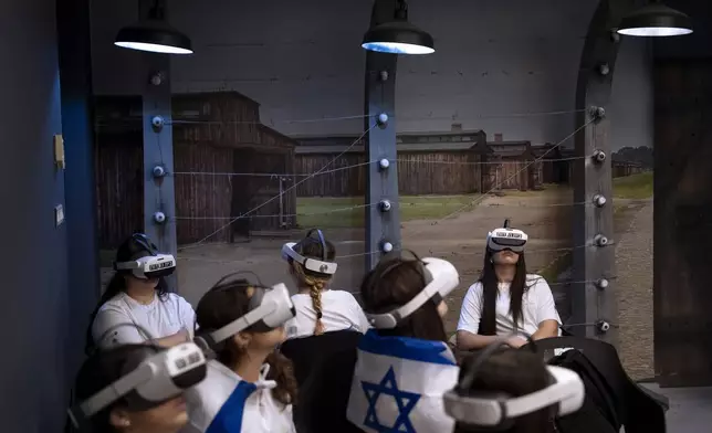Israeli students watch a virtual tour of the concentration and extermination camp Auschwitz-Birkenau at the Testimony House, a Holocaust museum in Nir Galim, Israel, on the eve of Israel's annual Holocaust Remembrance Day, Sunday, May 5, 2024. Israel holds the day of remembrance each year to remember the six million Jewish victims of the Nazi genocide during World War II. (AP Photo/Oded Balilty)