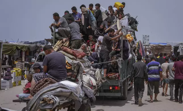 Palestinians fleeing from the southern Gaza city of Rafah during an Israeli ground and air offensive in the city on Tuesday, May 28, 2024. (AP Photo/Abdel Kareem Hana)