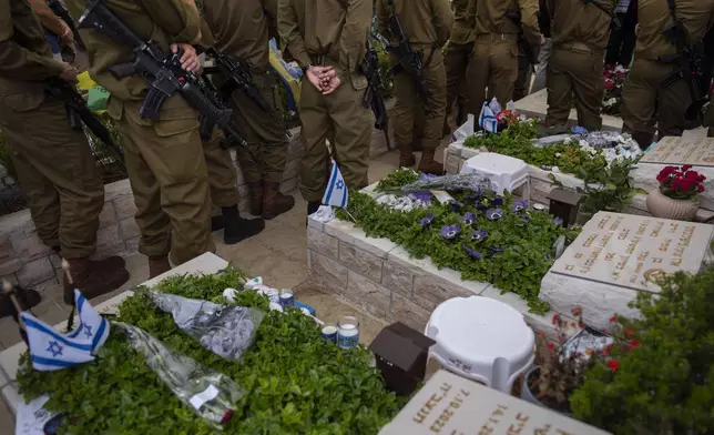 Israeli soldiers attend the funeral of Sgt. Itay Livny at Kiryat Shaul military cemetery in Tel Aviv, Israel, Sunday, May 12, 2024. Livny ,19, was killed during Israel's ground operation in the Gaza Strip, where the Israeli army has been battling Palestinian militants in the war ignited by Hamas' Oct. 7 attack into Israel. (AP Photo/Oded Balilty)