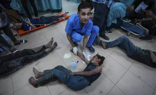 Palestinians wounded in the Israeli bombardment of the Gaza Strip are brought to Al Aqsa hospital in Deir al Balah, Gaza Strip, Tuesday, May 21, 2024. (AP Photo/Abdel Kareem Hana)