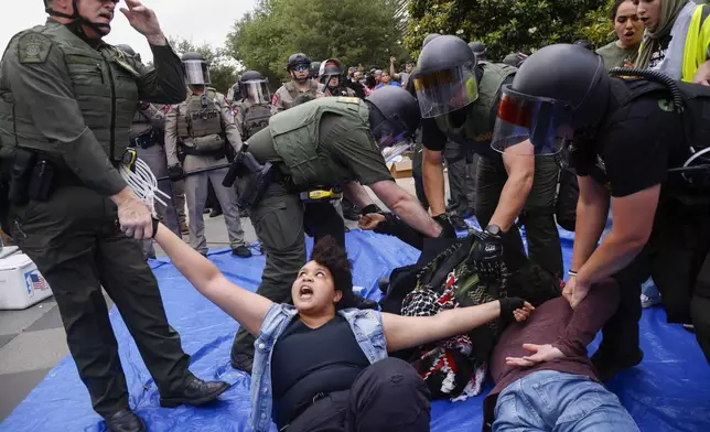 Protesters are taken into custody as law enforcement dismantle an encampment by pro-Palestinian students at the University of Texas at Dallas' Chess Plaza on Wednesday, May 1, 2024, in Richardson, Texas. (Juan Figueroa/The Dallas Morning News via AP)