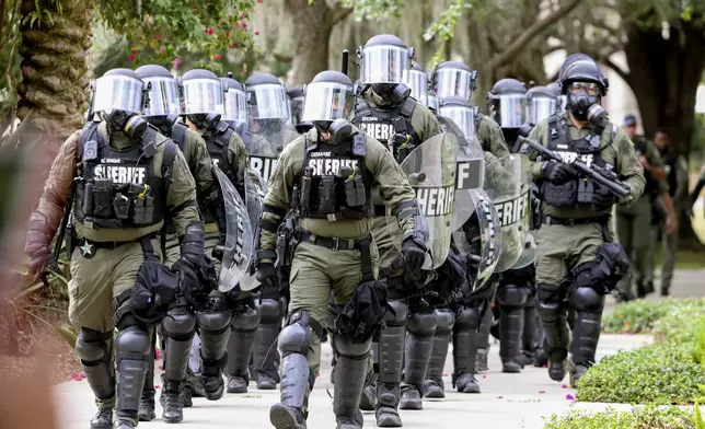 Law enforcement officers descend on pro-Palestinian protesters as they congregate at MLK Plaza at the University of South Florida, Tuesday, April 30, 2024, in Tampa, Fla. (Douglas R. Clifford/Tampa Bay Times via AP)