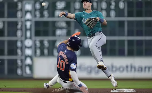 Seattle Mariners shortstop Dylan Moore, right, turns a double play on Houston Astros' Victor Caratini after forcing out Joey Loperfido (10) at second base during the eighth inning of a baseball game Saturday, May 4, 2024, in Houston. (AP Photo/Kevin M. Cox)