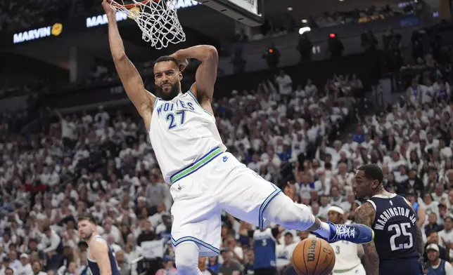 Minnesota Timberwolves center Rudy Gobert (27) scores against the Dallas Mavericks during the second half in Game 1 of the NBA basketball Western Conference finals, Wednesday, May 22, 2024, in Minneapolis. (AP Photo/Abbie Parr)
