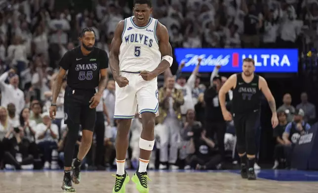 Minnesota Timberwolves guard Anthony Edwards (5) celebrates after making a 3-point shot against the Dallas Mavericks during the first half of Game 2 of the NBA basketball Western Conference finals, Friday, May 24, 2024, in Minneapolis. (AP Photo/Abbie Parr)