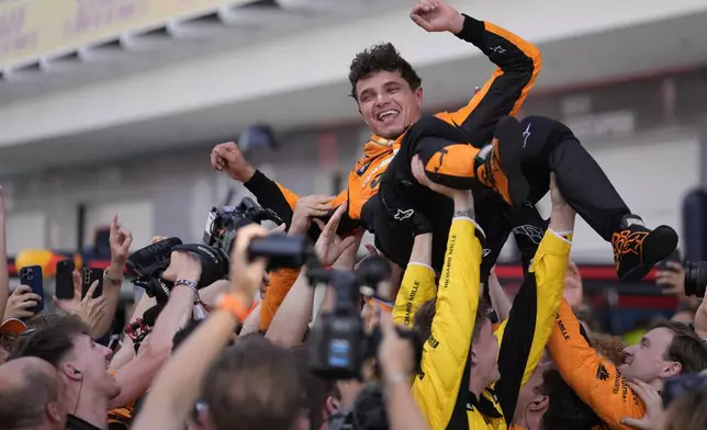 McLaren driver Lando Norris, of Britain, is lifted after winning the Miami Formula One Grand Prix auto race Sunday, May 5, 2024, in Miami Gardens, Fla. (AP Photo/Rebecca Blackwell)