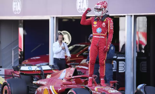 Ferrari driver Charles Leclerc of Monaco celebrates his pole position after the qualifying session ahead of the Formula One Monaco Grand Prix at the Monaco racetrack, in Monaco, Saturday, May 25, 2024. (AP Photo/Luca Bruno)