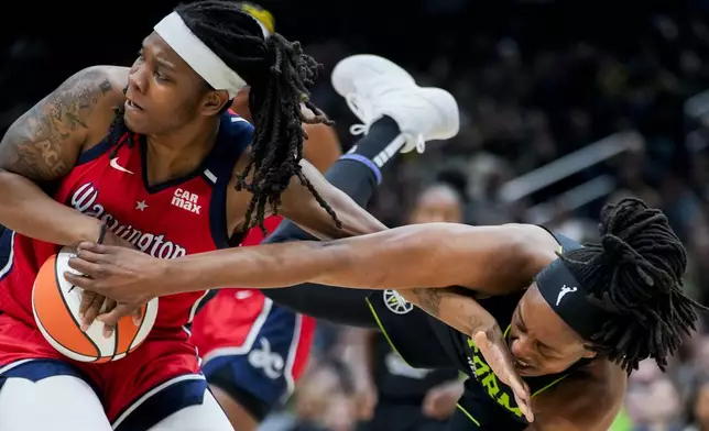 Seattle Storm forward Nneka Ogwumike, right, is hit on the face by the hand of Washington Mystics forward Myisha Hines-Allen, left, as they vied for the ball during the first half of a WNBA basketball game Saturday, May 25, 2024, in Seattle. (AP Photo/Lindsey Wasson)