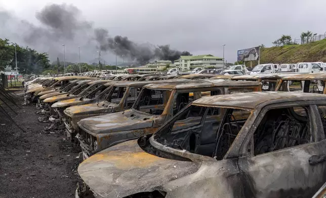 Burnt cars are lined up after unrest in Noumea, New Caledonia, Wednesday May 15, 2024. France has imposed a state of emergency in the French Pacific territory of New Caledonia. The measures imposed on Wednesday for at least 12 days boost security forces' powers to quell deadly unrest that has left four people dead, erupting after protests over voting reforms. (AP Photo/Nicolas Job)