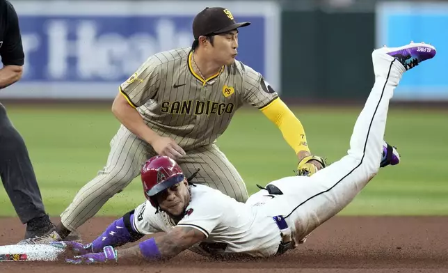 Arizona Diamondbacks' Ketel Marte, right, slides safely into second base with a double as San Diego Padres shortstop Ha-Seong Kim, of South Korea, applies a late tag during the first inning of a baseball game Friday, May 3, 2024, in Phoenix. (AP Photo/Ross D. Franklin)