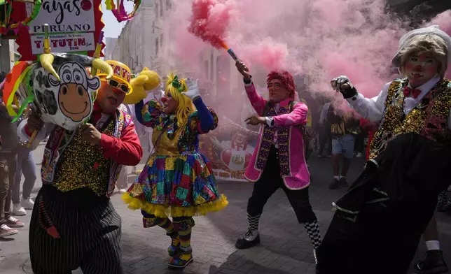 Clowns celebrate The Day of the Peruvian Clown in downtown Lima, Peru, Saturday, May 25, 2024. Professional clowns gather annually on this date to honor the beloved clown "Tony Perejil" who died on May 25, 1987 and was known as "the clown of the poor" because he performed in low-income neighborhoods to which he would donate a portion of his earnings. (AP Photo/Martin Mejia)