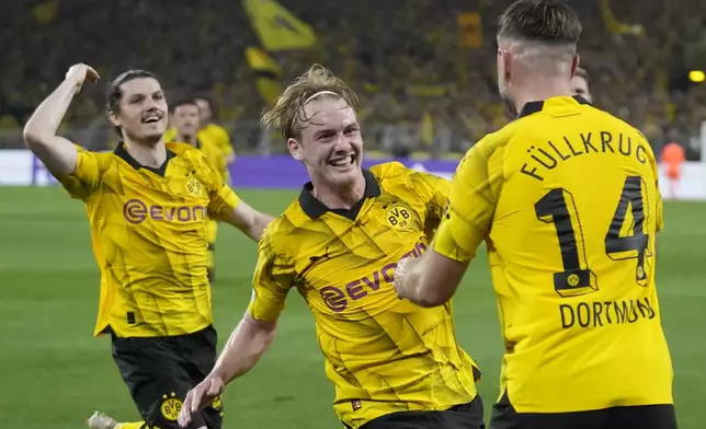 Dortmund's Niclas Fuellkrug, right, celebrates after scoring his side's opening goal during the Champions League semifinal first leg soccer match between Borussia Dortmund and Paris Saint-Germain at the Signal-Iduna Park stadium in Dortmund, Germany, Wednesday, May 1, 2024. (AP Photo/Matthias Schrader)