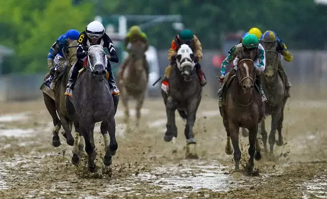 Jaime Torres, left, atop Seize The Grey, leads the pack while winning the Preakness Stakes horse race at Pimlico Race Course, Saturday, May 18, 2024, in Baltimore. (AP Photo/Nick Wass)