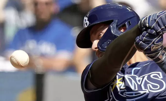 Tampa Bay Rays' Jonny DeLuca (21) keeps his eye on the ball as he hits it foul during the fourth inning of a baseball game against the Toronto Blue Jays, Saturday, May 18, 2024, in Toronto. (Chris Young/The Canadian Press via AP)