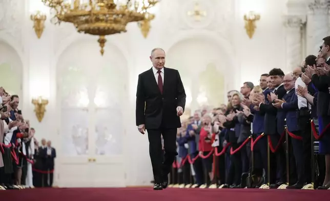 Vladimir Putin walks to take his oath as Russian president during an inauguration ceremony in the Grand Kremlin Palace in Moscow, Russia, Tuesday, May 7, 2024. (AP Photo/Alexander Zemlianichenko, Pool)