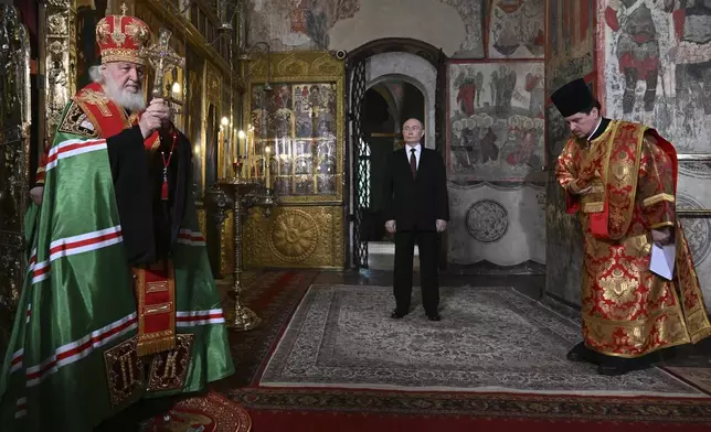 Russian President Vladimir Putin, center, attends a prayer service conducted by Patriarch Kirill of Moscow and all Russia, left, following an inauguration ceremony at the Kremlin's Annunciation Cathedral in Moscow, Russia, Tuesday, May 7, 2024. (Alexey Maishev, Sputnik, Kremlin Pool Photo via AP)