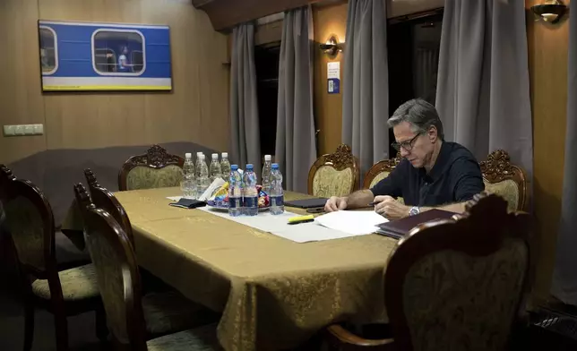 U.S. Secretary of State Antony Blinken works while traveling on a Ukraine Railways train to Kyiv, Monday, May 13, 2024, near Lviv, Ukraine. (Brendan Smialowski/Pool Photo via AP)