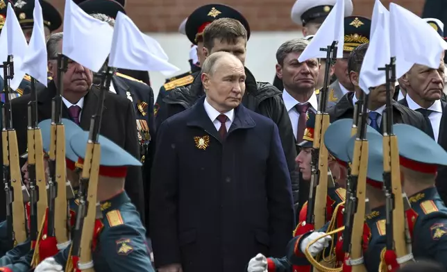 Russian President Vladimir Putin, center, attends a wreath-laying ceremony at the Tomb of the Unknown Soldier after the Victory Day military parade in Moscow, Russia, Thursday, May 9, 2024. (Maxim Blinov, Sputnik, Kremlin Pool Photo via AP)