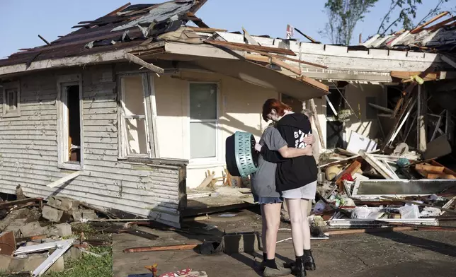 Joy King, left, and her granddaughter Crystal Maxey hug in front of King's house that was destroyed by a tornado Tuesday, May 7, 2024 in Barnsdall, Okla. The two were looking for King's cats and salvaging what items they could. (Mike Simons/Tulsa World via AP)