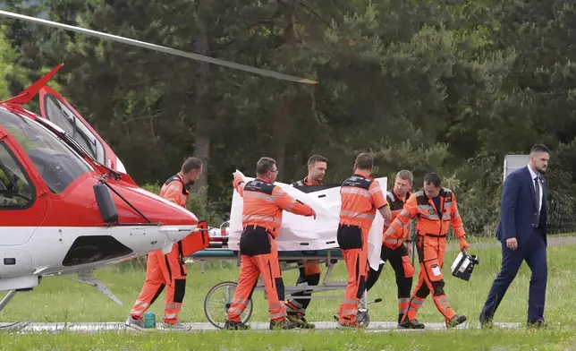 Rescue workers wheel Slovak Prime Minister Robert Fico, who was shot and injured, to a hospital in the town of Banska Bystrica, central Slovakia, Wednesday, May 15, 2024. Slovakia's populist Prime Minister Robert Fico is in life-threatening condition after being wounded in a shooting Wednesday afternoon, according to his Facebook profile. (Jan Kroslak/TASR via AP)