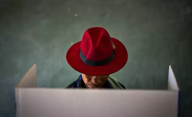 A voter fills out a ballot paper during general elections in Nkandla, Kwazulu Natal, South Africa, Wednesday May 29, 2024. South Africans are voting in an election seen as their country's most important in 30 years, and one that could put them in unknown territory in the short history of their democracy, the three-decade dominance of the African National Congress party being the target of a new generation of discontent in a country of 62 million people — half of whom are estimated to be living in poverty. (AP Photo/Emilio Morenatti)