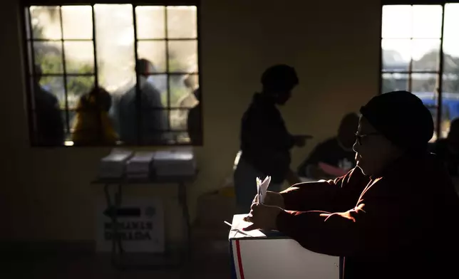 A woman casts her ballot on Wednesday May 29, 2024, during general elections in KwaMfana, South Africa. South Africans are voting in an election seen as their country's most important in 30 years, and one that could put them in unknown territory in the short history of their democracy, the three-decade dominance of the African National Congress party being the target of a new generation of discontent in a country of 62 million people — half of whom are estimated to be living in poverty. (AP Photo/Emilio Morenatti)