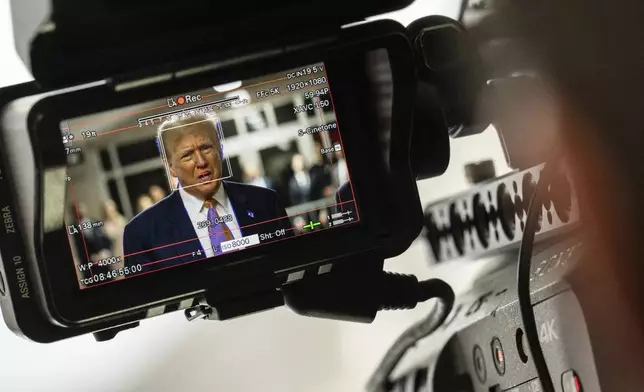 Former President Donald Trump, seen through a camera viewfinder, speaks to members of the media at Manhattan criminal court in New York, on Thursday, May 2, 2024. (Jeenah Moon/Pool Photo via AP)