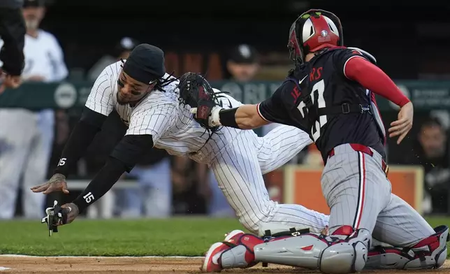 Chicago White Sox's Martín Maldonado is tagged out a home by Minnesota Twins catcher Ryan Jeffers during the third inning of a baseball game Tuesday, April 30, 2024, in Chicago. (AP Photo/Erin Hooley)