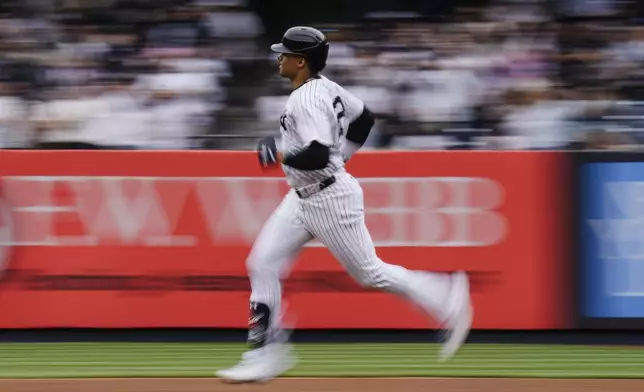 In this image taken with a slow shutter speed, New York Yankees' Juan Soto runs the bases after hitting a home run during the first inning of a baseball game against the Chicago White Sox, Saturday, May 18, 2024, in New York. (AP Photo/Frank Franklin II)