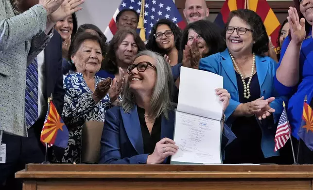 Arizona Gov. Katie Hobbs smiles after signing the repeal of the Civil War-era near-total abortion ban, Thursday, May 2, 2024, at the Capitol in Phoenix. Democrats secured enough votes in the Arizona Senate to repeal the ban on abortions that the state's highest court recently allowed to take effect. (AP Photo/Matt York)
