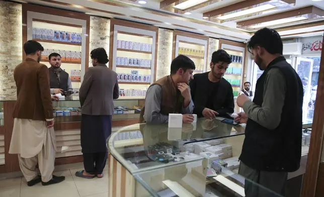 Afghans buy mobile phones in Kabul, Afghanistan, on Tuesday, April 23, 2024. (AP Photo/Siddiqullah Alizai)
