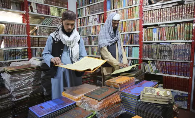 Afghans read books in a specialized religious bookstore in Kabul, Afghanistan, Tuesday, April 23, 2024. (AP Photo/Siddiqullah Alizai)