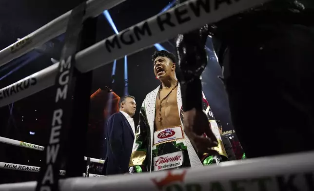 Jaime Munguia motions from the ring before fighting Canelo Alvarez in a super middleweight title fight Saturday, May 4, 2024, in Las Vegas. (AP Photo/John Locher)