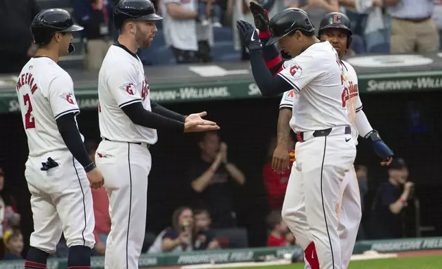 Cleveland Guardians' David Fry, center left, congratulates Bo Naylor, right, for his grand slam with Tyler Freeman (2), and Jose Ramirez during the sixth inning of a baseball game against the Los Angeles Angels in Cleveland Saturday, May 4, 2024. (AP Photo/Phil Long)