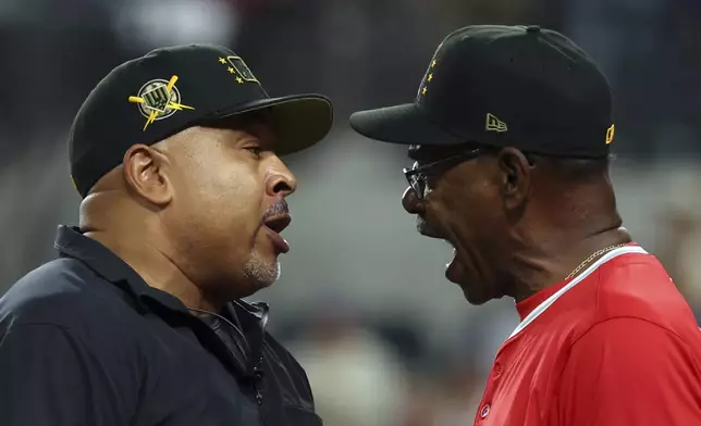 Third base umpire Adrian Johnson and Los Angeles Angels manager Ron Washington (37) have words in the 13th inning of a baseball game Saturday, May 18, 2024, in Arlington, Texas. (AP Photo/Richard W. Rodriguez)