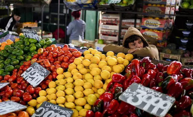 A vendor waits for customers at the central market for fruit and vegetables in Buenos Aires, Argentina, Friday, May 10, 2024. (AP Photo/Natacha Pisarenko)
