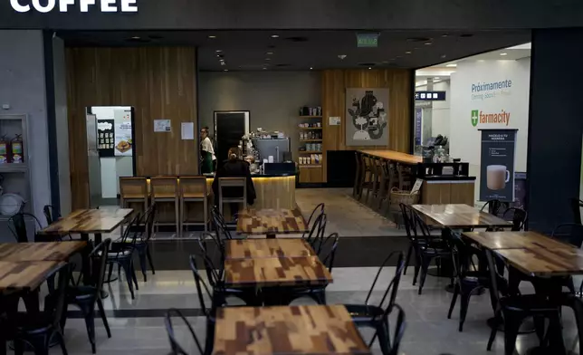 Tables are empty at a cafe that is open for business at Jorge Newbery International Airport during a general strike against the reforms of President Javier Milei in Buenos Aires, Argentina, Thursday, May 9, 2024. (AP Photo/Natacha Pisarenko)