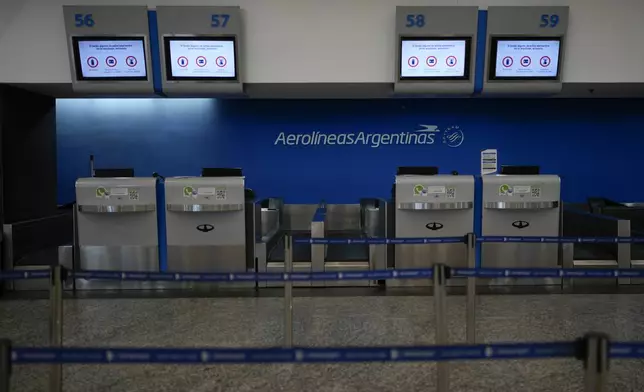 The Aerolíneas Argentinas counter is closed at Jorge Newbery International Airport during a general strike against the reforms of President Javier Milei in Buenos Aires, Argentina, Thursday, May 9, 2024. (AP Photo/Natacha Pisarenko)