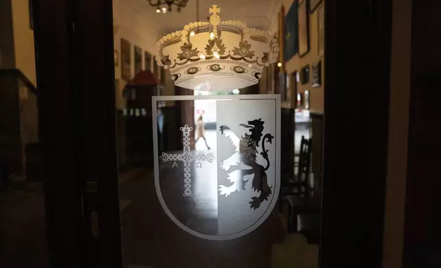 A coat of arms decorates the door of the Spanish restaurant Paxapoga in Buenos Aires, Argentina, Tuesday, May 21, 2024. A diplomatic crisis between historic allies Spain and Argentina expanded Tuesday as Spain announced the official withdrawal of its ambassador. (AP Photo/Rodrigo Abd)