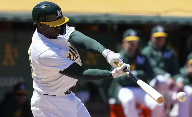 Oakland Athletics' Daz Cameron hits an RBI single against the Houston Astros during the sixth inning of a baseball game Saturday, May 25, 2024, in Oakland, Calif. (AP Photo/Godofredo A. Vásquez)
