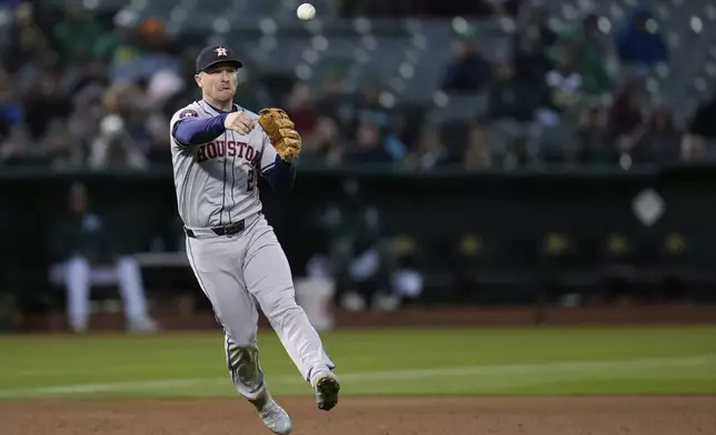 Houston Astros third baseman Alex Bregman throws to first for the out on Oakland Athletics' Miguel Andujar during the fifth inning of a baseball game Friday, May 24, 2024, in Oakland, Calif. (AP Photo/Godofredo A. Vásquez)